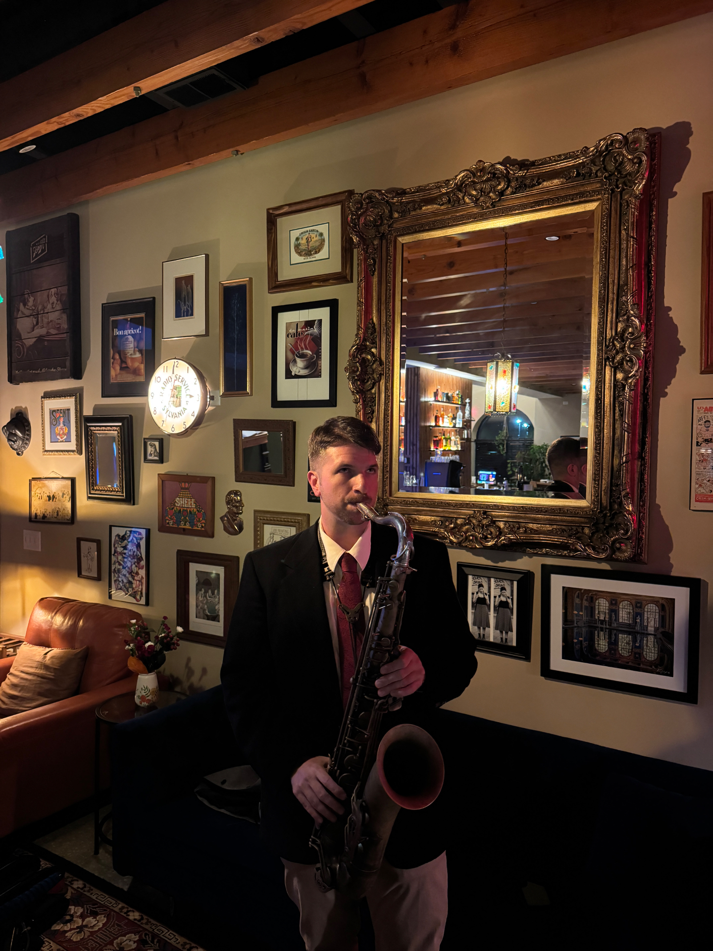 A saxophonist playing beside the bar at Oak & Alchemy