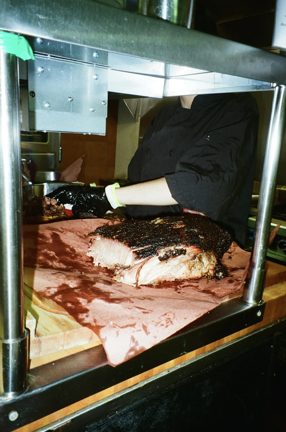 Slow-smoked brisket sliced on butcher paper at Oak & Alchemy in Woodstock, IL