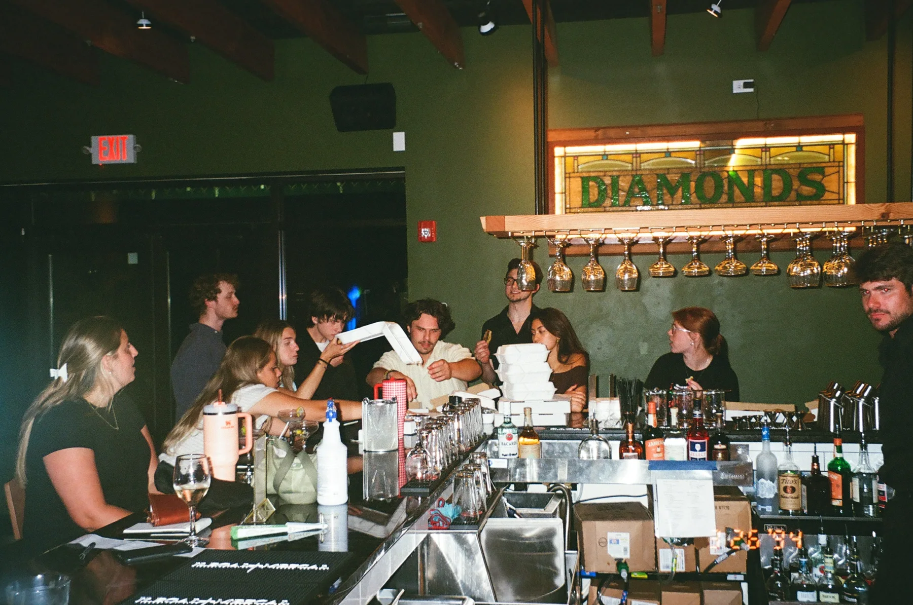 Friends gathered at the warm, wood-accented Oak & Alchemy bar