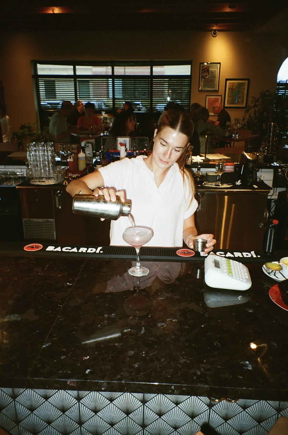 A bartender preparing a drink at Oak & Alchemy